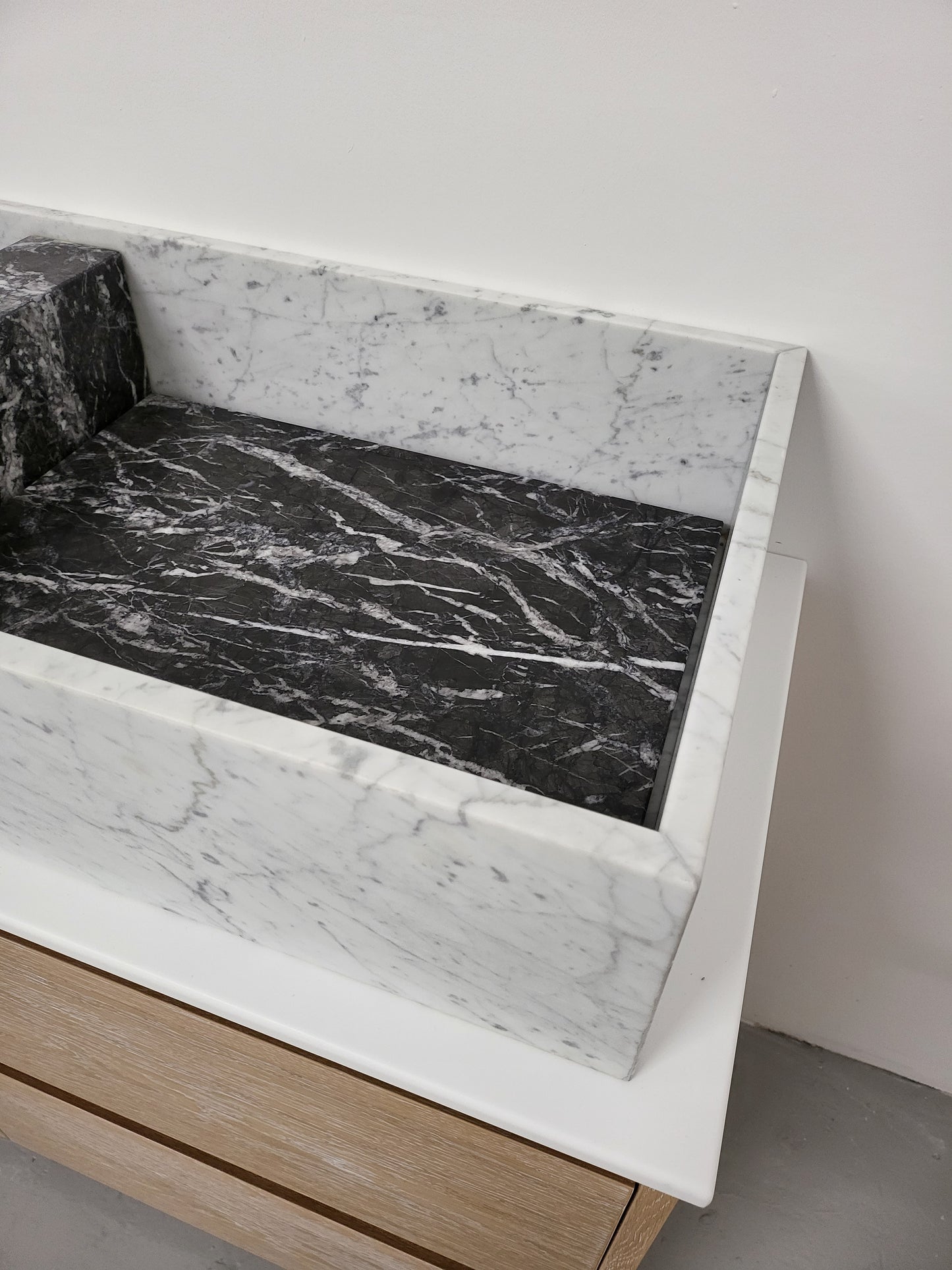Carrara & Nero Marquina sit on basin